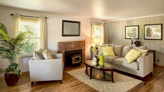 Living room with sofa, armchair, and fireplace