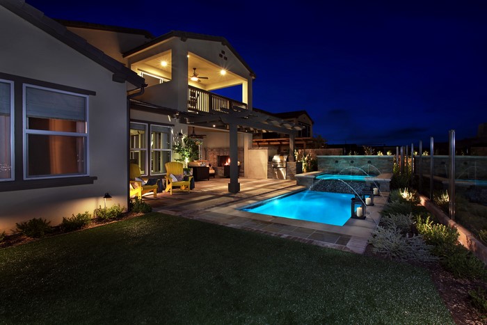 Luxury Backyard with Pool and Outdoor Kitchen at Night