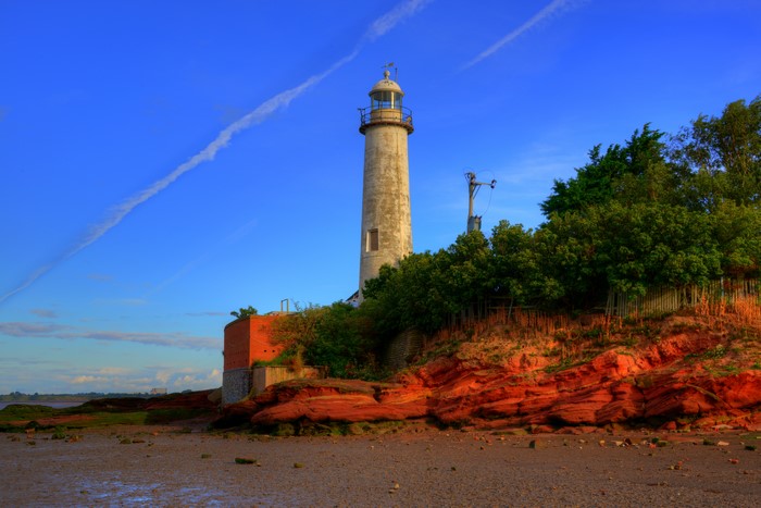 Lighthouse on a rocky shore in Hale, England