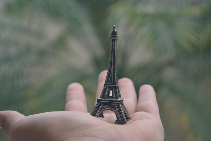 Miniature Eiffel Tower souvenir held in hand