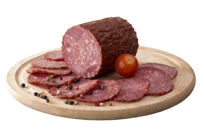 Sausage and tomato on a wooden board
