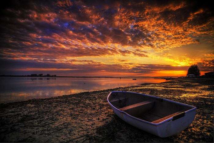 Boat on a shore during sunset