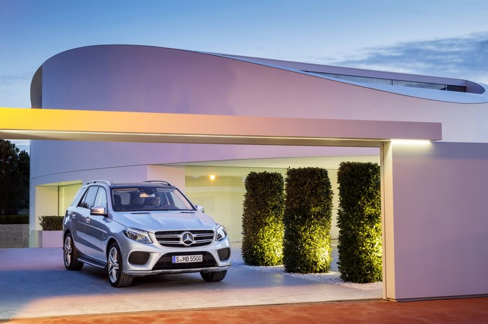 Silver Mercedes-Benz GLE 500 parked in front of modern architecture