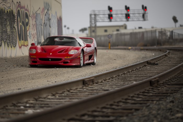Red Ferrari F50 on Railroad Tracks