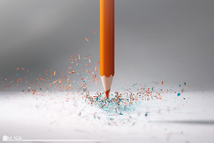 Orange pencil sharpening with colorful shavings