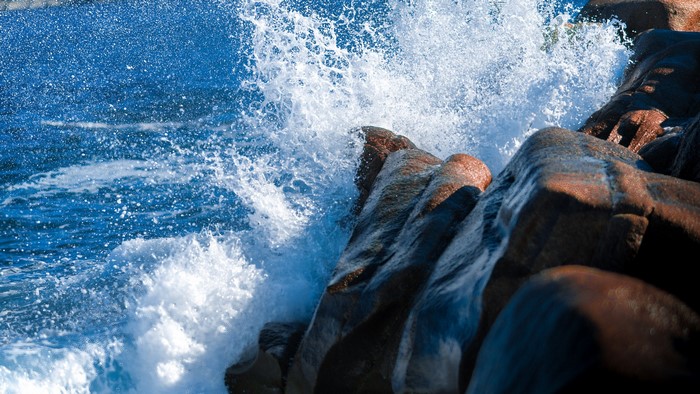 Ocean waves crashing against rocky shore