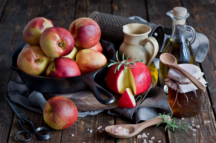 Nectarines, Cheese, Honey, and Olive Oil on Wooden Table