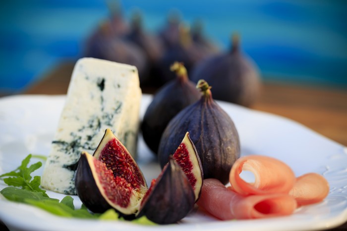 Still-life of figs, blue cheese, and ham