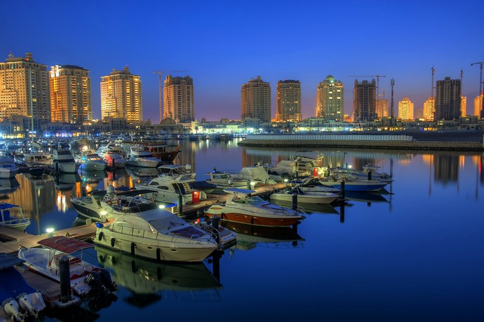 Doha Qatar Marina with Yachts and Buildings at Night