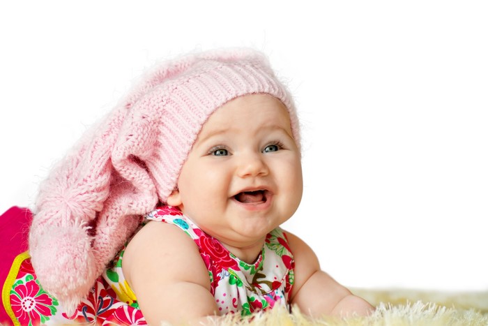 Baby wearing a pink winter hat and floral dress