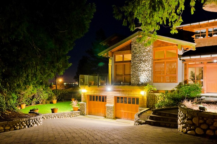 Luxury house with garage and garden at night
