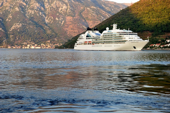 Cruise liner sailing on the sea near mountains in Montenegro