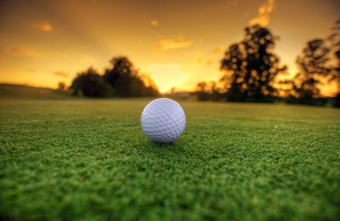 Golf ball on a golf course at sunset
