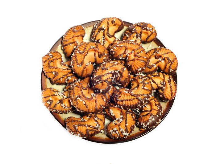 Plate of chocolate drizzled cookies with coconut flakes