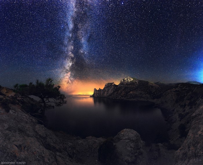 Milky Way over a rocky coast and sea at night