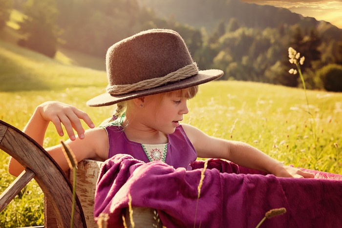 Little girl in a hat in a field
