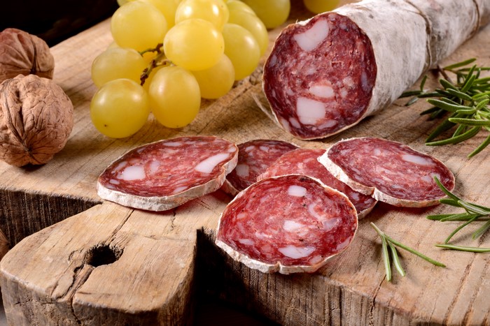 Sausage, Grapes, and Walnuts on a Wooden Board
