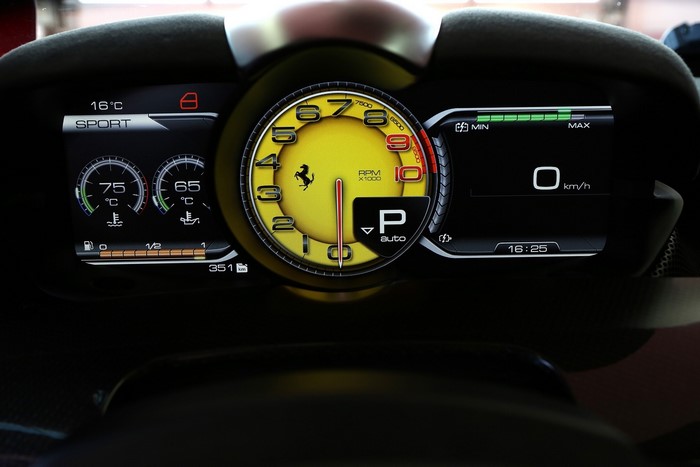 Ferrari car dashboard with tachometer and digital displays