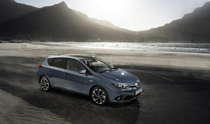 2015 Toyota Auris Hybrid on a beach with mountains