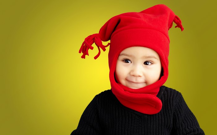 Baby wearing a red winter hat