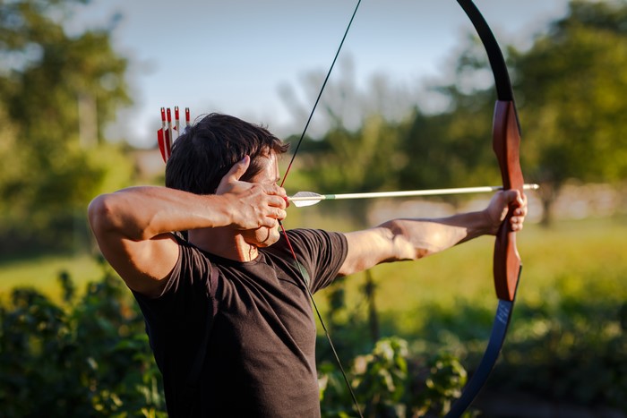 Man aiming a bow and arrow