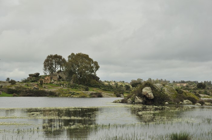 Rocky landscape with a lake under cloudy sky
