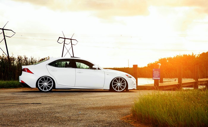 White Lexus IS F-sport parked by a dock
