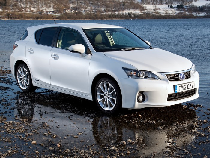 White Lexus CT 200h parked by a lake