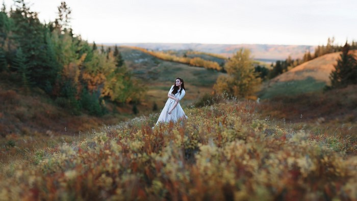 Woman in a dress in autumn landscape