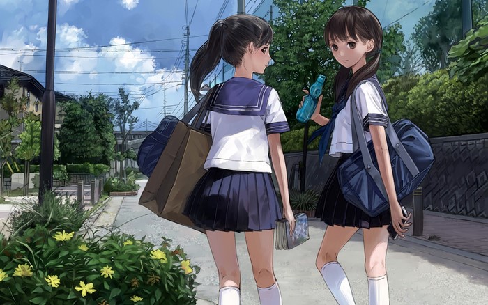 Two schoolgirls walking on a street