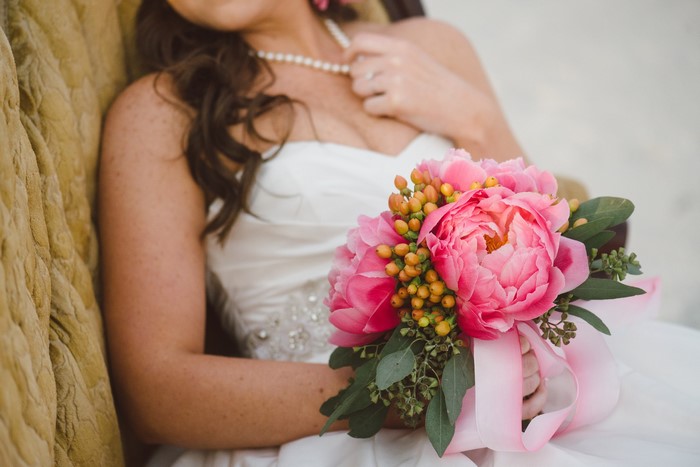 Bride holding a pink peony bouquet