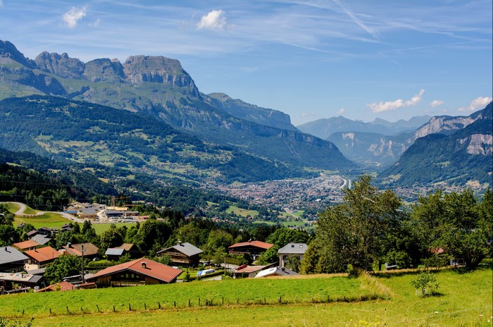 Mountain Valley Village with Houses and Grasslands
