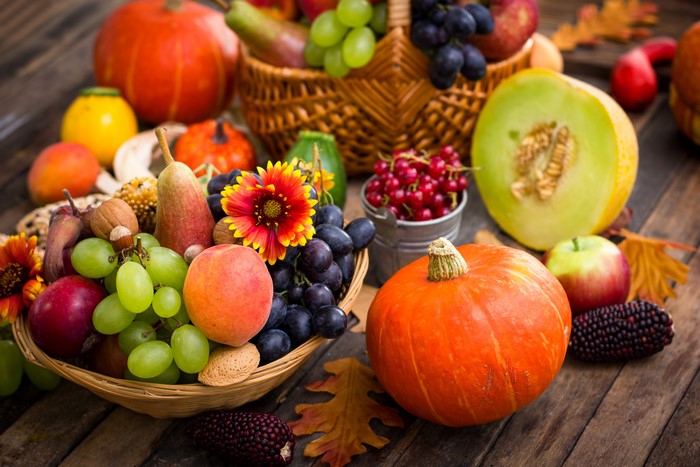 Autumn harvest with pumpkins, grapes, apples, and melons