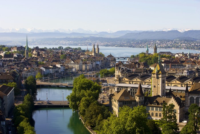 Zurich, Switzerland cityscape with river and mountains