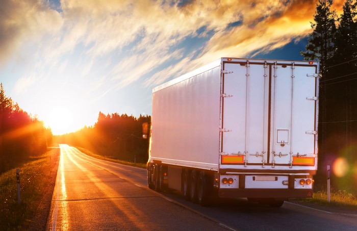 White truck on a road at sunset