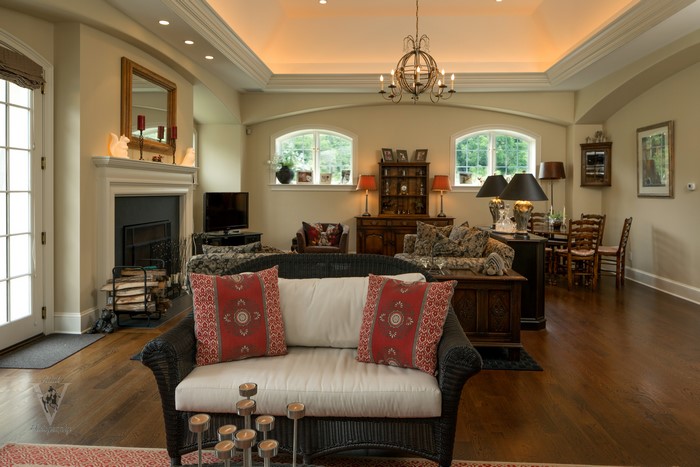 Living room with fireplace, sofa, and chandelier