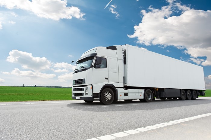 White semi-truck driving on a highway