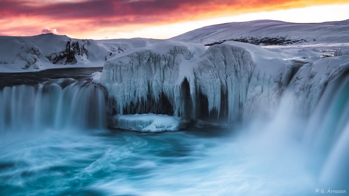 Frozen waterfall in Iceland during sunset
