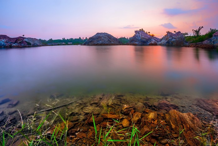 Lake with rocky shores at sunset