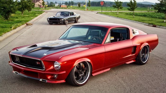 Red and Black Ford Mustang Fastbacks on Road