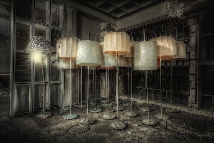 Abandoned room with many floor lamps