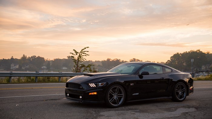 Black 2014 Roush Stage 2 Mustang by a lake