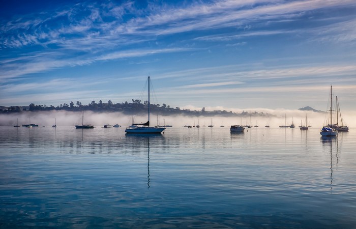 Sailboats and Motorboats in Foggy Harbor