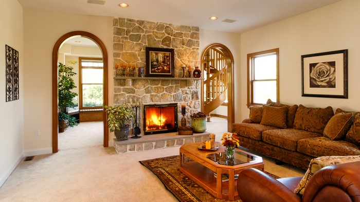 Living room with fireplace, sofa, and arched doorway