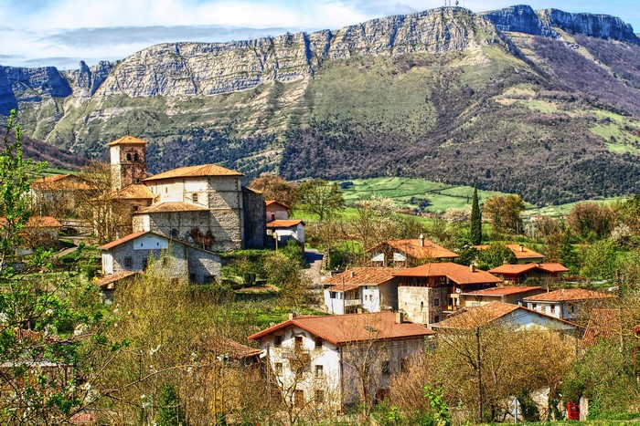 Village with church at the foot of a mountain in Alava, Spain