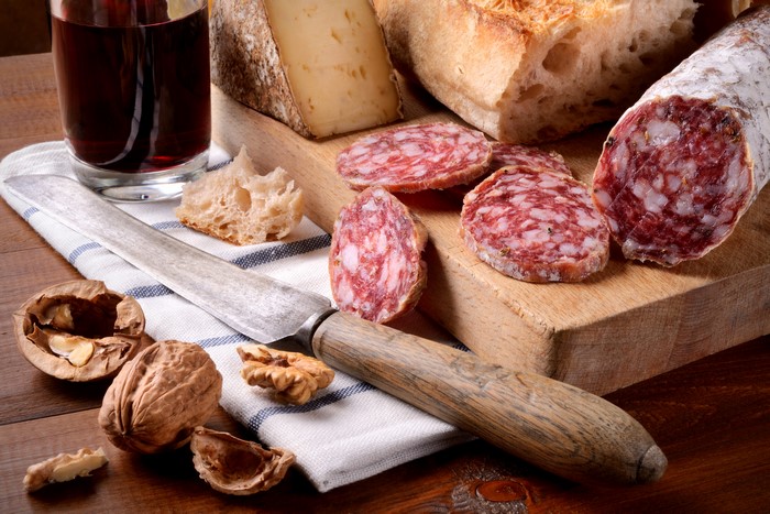 Sausage, Cheese, Bread, Wine, and Walnuts with Knife
