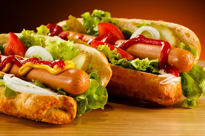Hot dogs with vegetables and condiments