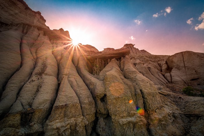 Sun rays over eroded rock formations in Canada