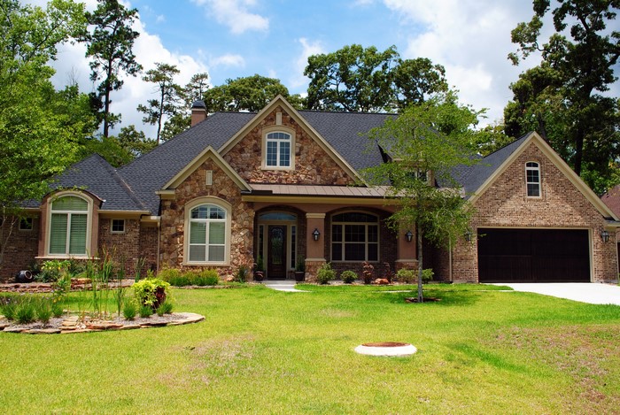 Luxury brick and stone house with a large lawn