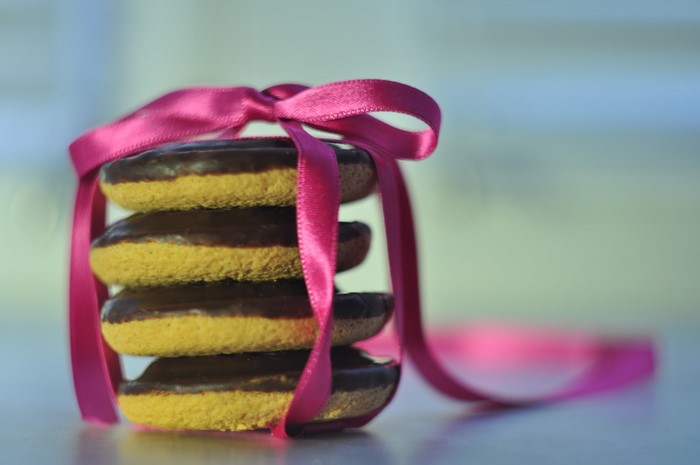Stack of chocolate-covered cookies tied with a pink ribbon